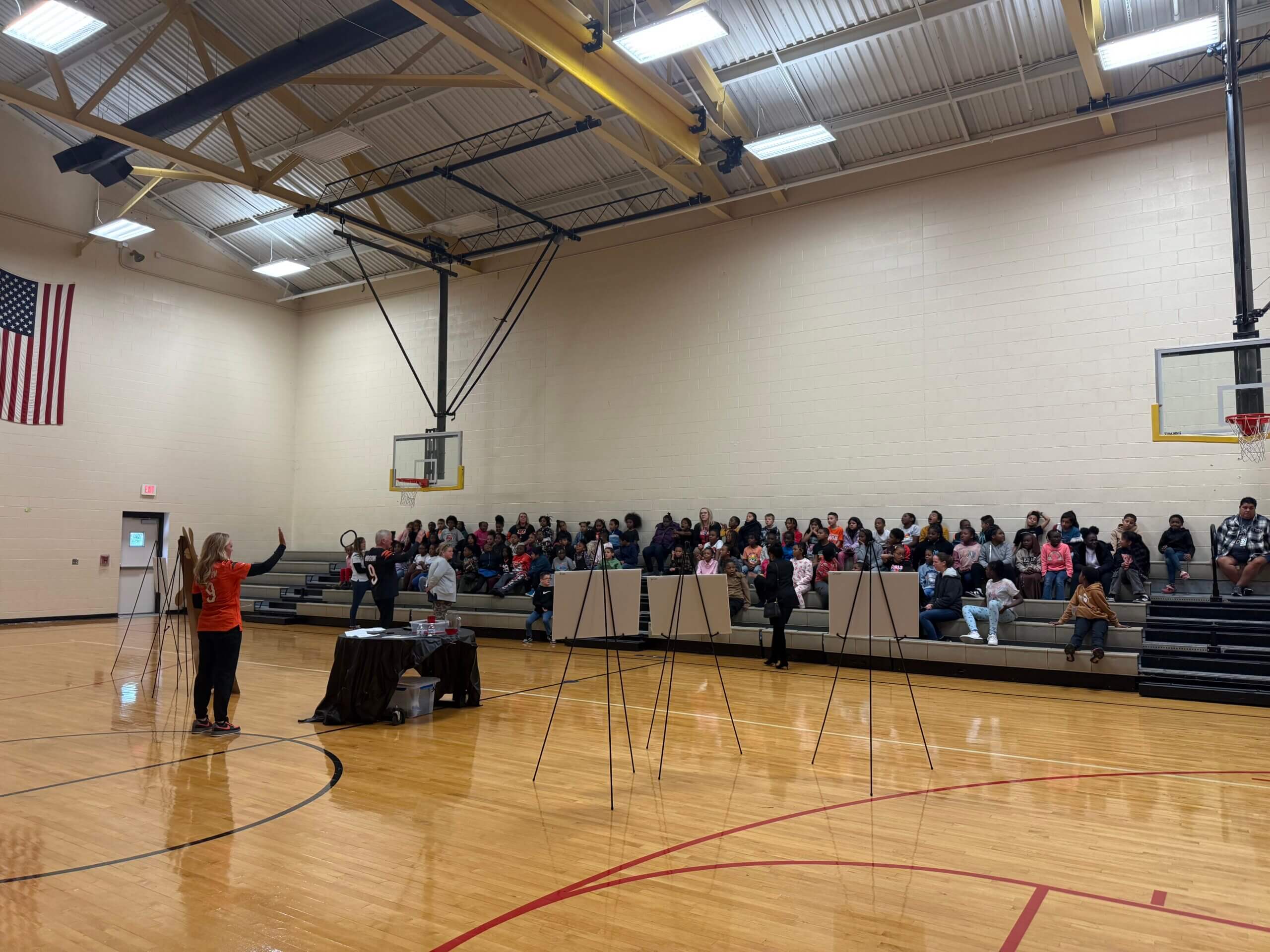 Robin and Jim Burrow talking to the students at Roll Hill Academy during their Healthy Body Healthy Mind event about using the food groups to eat healthy