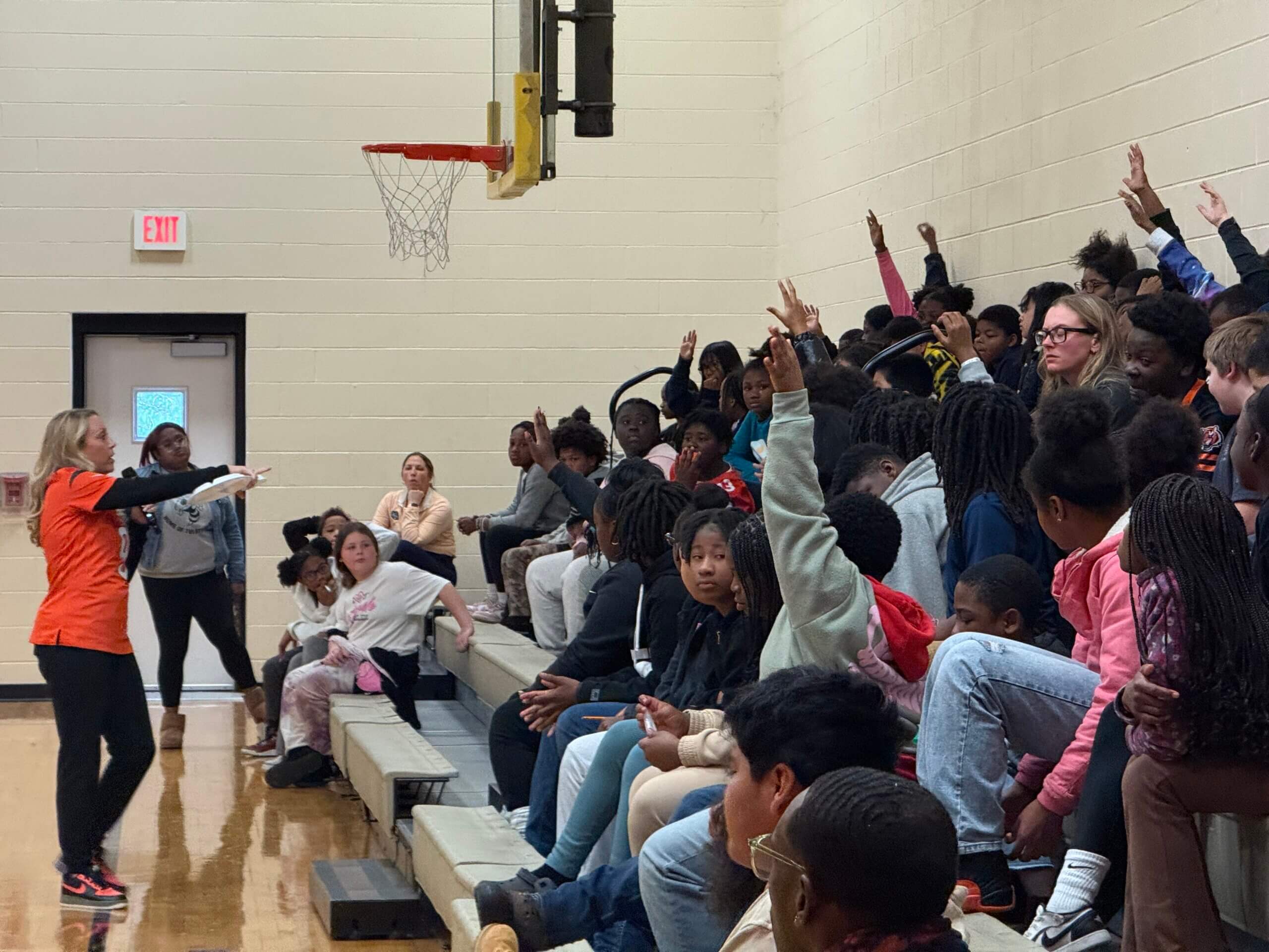 Robin and Jim Burrow speaking to the students at Roll Hill Academy during their Healthy Body Healthy Mind event about using the food groups to eat healthy.