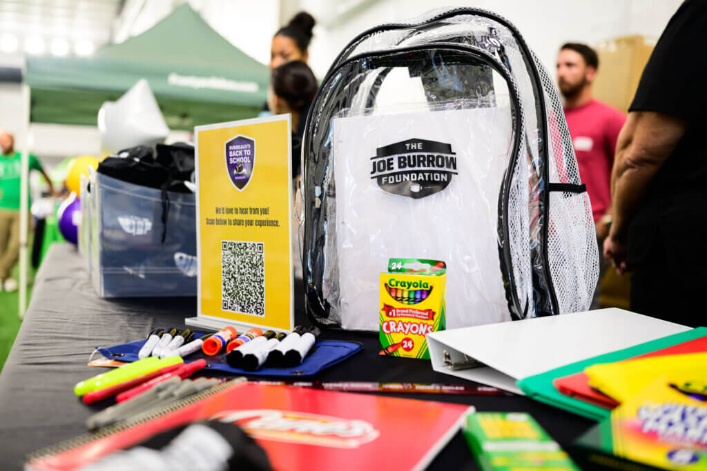 The Joe Burrow Foundation backpack and school supplies on a table at The Joe Burrow Foundation's second-annual Burreaux's Back-to-School Kickoff.
