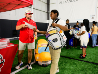 GS_0281 Raising Canes CEO at the Raising Canes booth handing out school supplies to kids at The Joe Burrow Foundation's second-annual Burreaux's Back-to-School Kickoff.