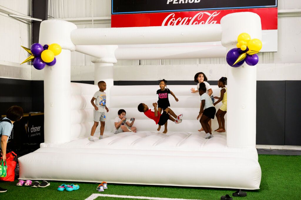 Children playing inside of an inflatable jumper at The Joe Burrow Foundation's second-annual Burreaux's Back-to-School Kickoff.