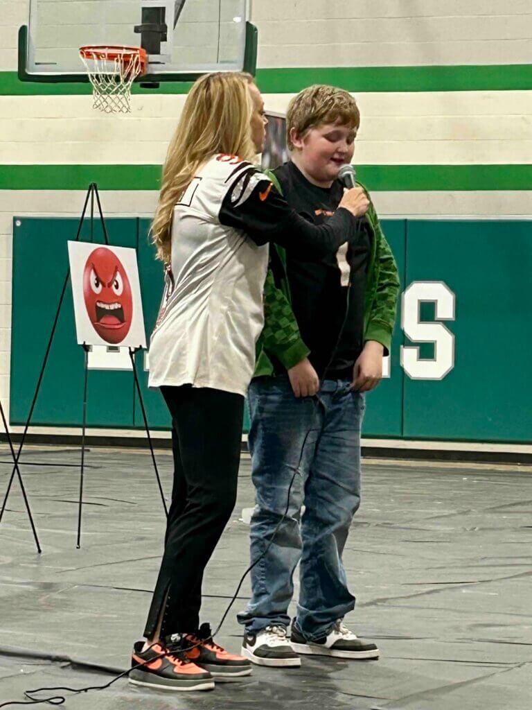 eastern_local_elementary_HBHM_boy Robin Burrow speaking with a boy at The Joe Burrow Foundation's Healthy Body, Healthy Minds event at Eastern Local Elementary School.